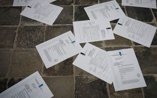 Papieren vog’s liggen verspreid over een stenen vloer.
