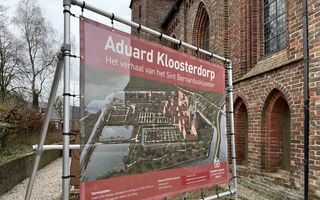 Een informatiebord over Aduard Kloosterdorp naast de oude Abdijkerk.