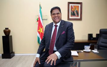 Man in formele kleding op bureau.