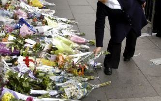 LONDEN â€“ Een islamitische vrouw legt bloemen bij het metrostation King’s Cross in Londen, waar donderdag een van de bomaanslagen werd gepleegd. Foto EPA