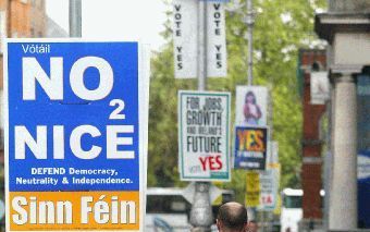 DUBLIN - Een vertegenwoordiger van Sinn Fein sjouwt met stembussen door de straten van de Ierse hoofdstad Dublin. Zaterdag kunnen de Ieren zich in een referendum uitspreken over de uitbreiding van de Europese Unie. - Foto EPA