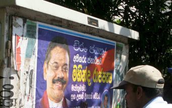 COLOMBO â€“ Een aanhanger van premier Mahinda Rajapakse hangt in de Sri Lankaanse hoofdstad Colombo posters op met felicitaties aan het adres van zijn kandidaat. Rajapakse versloeg gisteren met 50,3 procent van de stemmen zijn voornaamste rivaal bij de pr