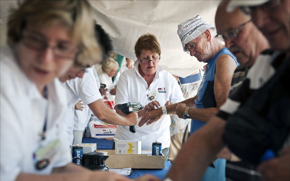 Wandelaars registreren zich maandag voor de Nijmeegse Vierdaagse op de Wedren, het start- en finishpaviljoen van de wandeltocht in Nijmegen. Deelnemers krijgen dit jaar voor het eerst een polsbandje om. Het nieuwe registratiesysteem moet zo illegale deeln