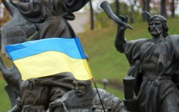 KIEV â€“ Een OekraÃ¯ens meisje zwaait met de nationale vlag tijdens een protest van de studentenbeweging Pora in het centrum van Kiev. Uit onvrede over het verloop van de presidentsverkiezingen van zondag zijn maandag op verschillende plaatsen in OekraÃ¯n