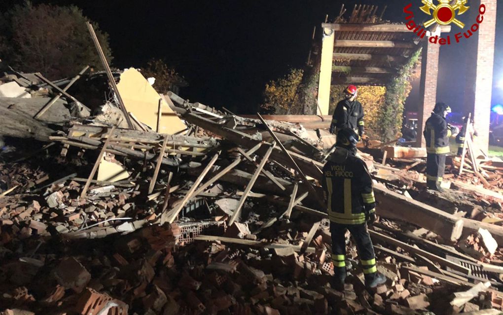 Italiaanse brandweermannen zoeken naar vermiste collega's in het puin van de ontplofte boerderij in Quargnento, Italië. beeld AFP