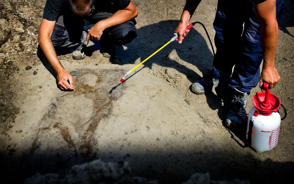 Archeologen zijn bezig met de opgravingen waar zij een prehistorisch graf hebben gevonden. Foto ANP