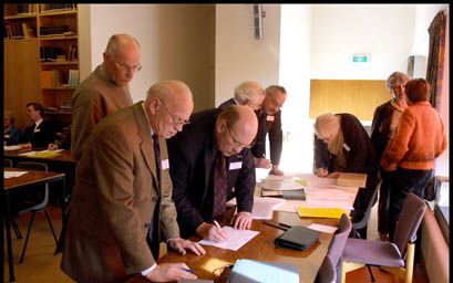 DOORN - Voorafgaand aan de vergadering van de gereformeerde synode vullen de afgevaardigden een formulier in om hun reiskosten te declareren. - Foto RD,(Henk(Visscher