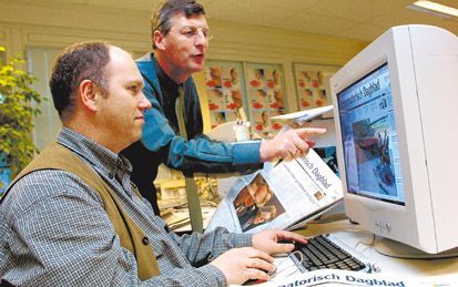 Chef-redacteur J. Leune (achter) en vormgever Alex van Pijkeren buigen zich over de nieuwe opmaak van het Reformatorisch Dagblad. De krant gaat vanaf woensdag 2 januari naar acht kolommen per pagina. - Foto RD,AntonDommerholt