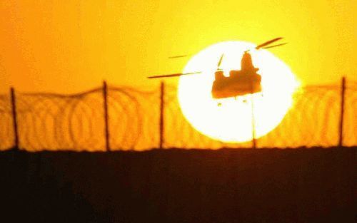 NASIRIYA - Terwijl de zon wegzakt achter de horizon verlaat een Chinook-helikopter de Italiaanse militaire basis Het Witte Paard in Nasiriyah, in het zuiden van Irak. De Amerikanen en met hen samenwerkende Irakezen beleefden een bloedig weekend, met tal v