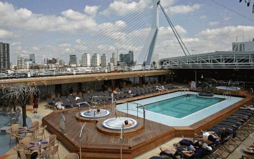 ROTTERDAM â€“ Toeristen genoten zaterdag op het zonnedek van cruiseschip Westerdam van het mooie weer. Het 300 meter lange cruiseschip lag een dag bij de Wilhelminapier in Rotterdam. Op de achtergrond de Erasmusbrug. Het luxe schip heeft een Nederlandse k