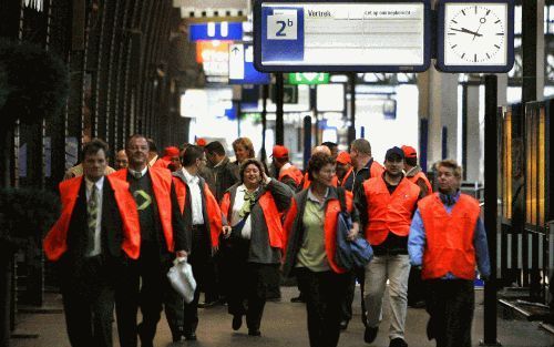 AMSTERDAM - NS-personeel is donderdagochtend op het Centraal Station in Amsterdam onderweg naar een stakingbijeenkomst met FNV-voorzitter Lodewijk de Waal. Het treinverkeer in Nederland ligt donderdagochtend tot dusver helemaal plat door de vakbondsacties