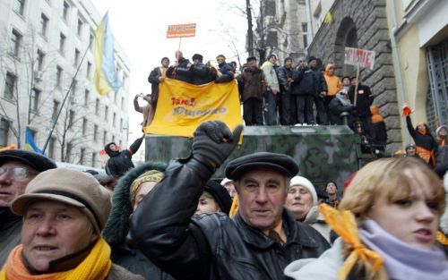 KIEV - Aanhangers van oppositieleider en presidentskandidaat Viktor Joesjtsjenko protesteren zaterdag bij het parlementsgebouw in Kiev. Foto EPA