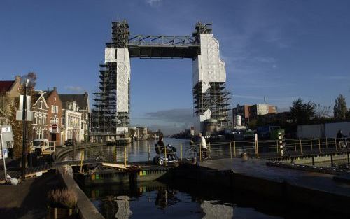 BOSKOOP â€“ De hefbrug van Boskoop staat nog in de steigers. Op de voorgrond de pontonbrug waarvan voetgangers en fietsers maandenlang dankbaar gebruikmaakten. Automobilisten en vrachtwagenchauffeurs waren minder te spreken over de afsluiting van de brug 