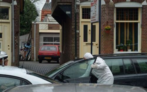 HILVERSUM â€“ Een rechercheur bij de woning aan de Hilvertsweg in Hilversum waar een politieagent afgelopen zaterdag met zijn dienstwapen zijn vrouw en drie kinderen ombracht en vervolgens de hand aan zichzelf sloeg. Foto ANP