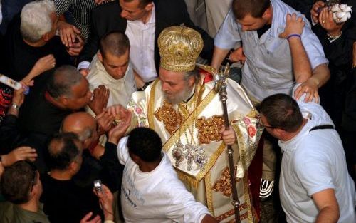 JERUZALEM â€“ De Grieks orthodoxe patriarch Irineos I betreedt, omringd door bodyguards, de Heilige Grafkerk in Jeruzalem voor de viering van het oosters orthodoxe paasfeest. Christelijke Palestijnen hadden gedreigd de kerkleider de toegang tot de kerk te