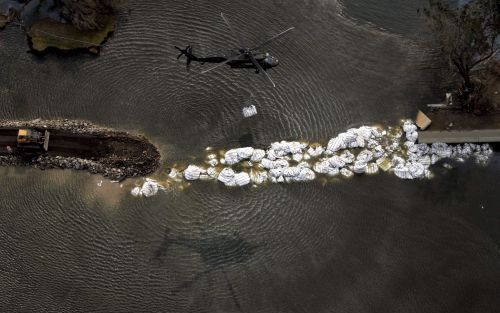 NEW ORLEANS - Een helikopter laat zandzakken vallen in een poging de oevers van het kanaal bij de 17th Street weer te herstellen. Foto's EPA