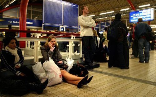 UTRECHT â€“ Gestrande treinreizigers op het Centraal Station van Utrecht wachten gelaten op de dingen die komen gaan. Een grote stroomstoring vrijdagavond legde het treinveerkeer van en naar Utrecht compleet stil. Tienduizenden reizigers kwamen daardoor n