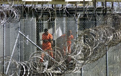 GUANTANAMO BAY â€“ Gestoken in oranje overalls wassen illegale strijders in het Amerikaanse gevangenkamp Guantanamo Bay zich, voorafgaande aan het middaggebed. Het overgrote deel van de in Afghanistan gevangen genomen al Qaida en Talibanstrijders wordt al