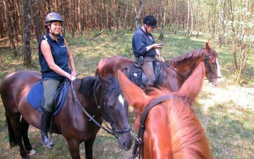 SCHAARSBERGEN â€“ Ruiters mogen sinds vorige week vrij door park De Hoge Veluwe rijden. Manegehouder Rik Steijn (r.) en zijn vriendin Inge van Soest (l.) maken daar dankbaar gebruik van. Foto RD