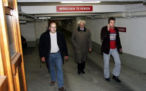 AMSTERDAM - Officier van Justitie Teeven (L) verlaat maandagavond de parkeergarage in Amsterdam-Zuid waar wordt gezocht naar lijken. Foto ANP