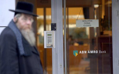 ANTWERPEN - Een joodse man passeert de overvallen ABN AMRO-bank in Antwerpen. Foto EPA