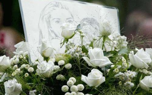 BERGEN - Een bloemstuk en een tekening van de vermoorde Marion (l.) en Romy van Buuren tijdens de uitvaartdienst in Bergen. Moeder en dochter lagen samen in de witte kist. - Foto anp