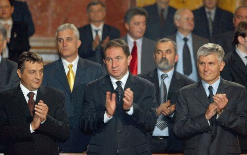 BELGRADO - De Joegoslavische premier Dragisa Pesic (m.), de Servische premier Zoran Djindjic (r.) en de Servische minister van Binnenlandse Zaken, Zoran Zivkovic (l.), applaudisseren net nadat besloten is dat JoegoslaviÃ« voortaan ServiÃ«-Montenegro heet.