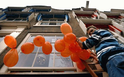 Inwoners van Deventer versieren historische gevels in de stad met allerlei oranje versieringen. Komende woensdag bezoekt koningin Beatrix de Koekstad met haar familie tijdens Koninginnedag.