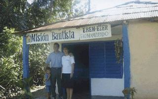 SANTIAGO â€“ Een predikant van een baptistenkerk in het binnenland van Oost Cuba met vrouw en zoontje. De voorganger heeft reden om blij te zijn: ook zijn eenvoudige kerkje wordt te klein door een toeloop van nieuwe kerkgangers. Foto SEZ