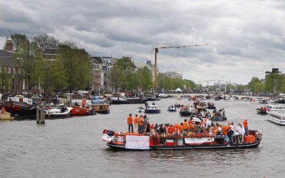 Boten op de Amsterdamse grachten tijdens Koninginnedag. Foto ANP