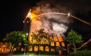 Een leegstaande kerk aan de Zaandijkstraat in Rotterdam is zondagavond door een grote brand verwoest. beeld ANP