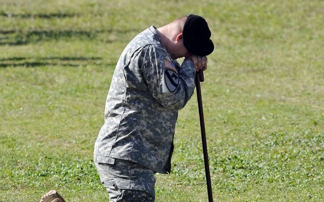 Een Amerikaanse soldaat herdenkt zijn omgekomen collega's na het bloedbad op de militaire basis Fort Hood in Texas. Foto EPA