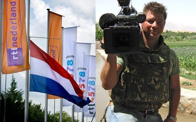 HILVERSUM - De Nederlandse vlag hangt halfstok bij het gebouw van RTL Nederland in Hilversum. Rechts cameraman Stan Storimans. Foto ANP