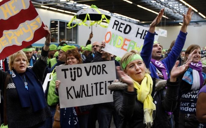 2008-11-19 AMSTERDAM - Een stakende leraar (L) heeft papa-dag en heeft de kinderen meegenomen naar de stakingsbijeenkomst. Leraren in het voortgezet onderwijs schrijven zich woensdag in Amsterdam in als staker. Na de inschrijving zullen ze per bus naar Ut