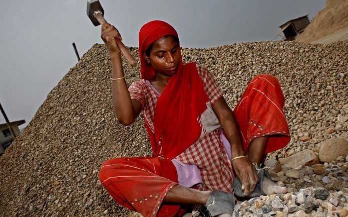 BANGLADESH - Een vrouw hakt stenen zonder handschoenen. Foto EPA