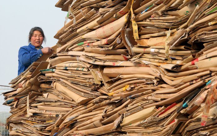 PEKING – Een arbeidsmigrant in Peking helpt met het uitladen van een truck met meer dan 5 ton recyclebaar karton. Hoewel arbeidsmigratie positief kan zijn voor de economie van zowel gast als thuisland, schort er veel aan de rechtsbescherming van de werker