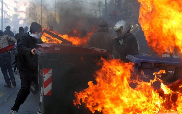 THESSALONIKI - Betogers die protesteerden tegen het doodschieten van een tiener door de politie van Athene hebben zondag in de Noord-Griekse stad Thessaloniki het gemeentehuis, een politiebureau en een bank aangevallen. Foto: EPA