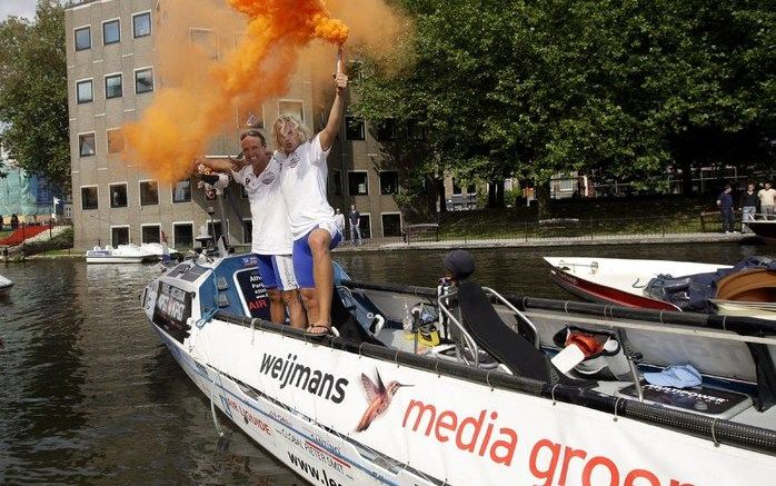 AMSTERDAM - Blijdschap bij Alex Mutsaars en Matthijs Houben (R) nadat zij woensdag na een reis van 4500 kilometer per waterfiets zijn aangekomen in Amsterdam. Het tweetal begon de reis in Athene en kwam via onder meer Rome, Marseille en Parijs aan in Nede