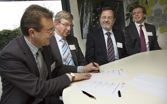 DEN HAAG – Ds. J. P. van Ark, ds. H. J. van der Veen, dr. A. J. Plaisier en ds. M. J. Tekelenburg (v.l.n.r.) ondertekenen een verklaring inzake meer samenwerking tussen Protestantse Kerk en IZB. Foto Christiaan Zielman