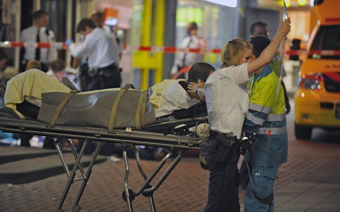 ROTTERDAM - Hulpverleners schieten zaterdagnacht de gewonden te hulp na de schietpartij in een cafe in Rotterdam. Bij een schietpartij in een cafe aan het Poolsterplein in Rotterdam zijn in de nacht van vrijdag op zaterdag zeker een dode en drie gewonden 