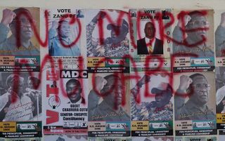 HARARE - Verkiezingsposters van president Mugabe zijn beklad met de teskt: No more Mugabe. Foto EPA