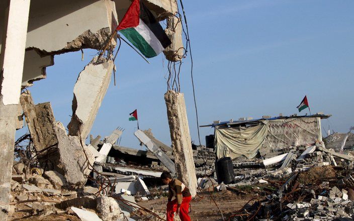 Een Palestijnse jongen bij de restanten van zijn huis in Gaza. Foto EPA