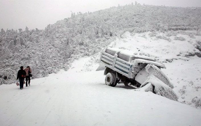 Een truck is van de weg geraakt tijdens een sneeuwstorm in het zuidwesten van China. Foto EPA