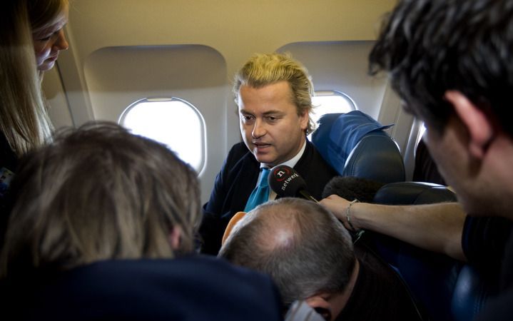 LONDEN - Wilders in het vliegtuig naar Londen, omstuwd door fotografen en journalisten. Foto ANP