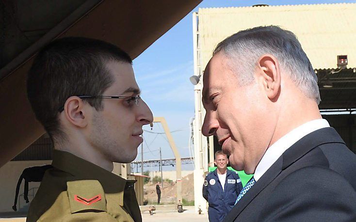 Gilad Shalit wordt dinsdag op de luchtmachtbasis Tel Nof begroet door premier Benjamin Netanyahu. Foto EPA