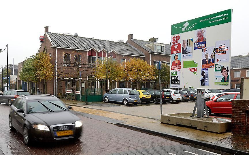 HAZERSWOUDE. Verkiezingsaffiches op een bord in Hazerswoude. De inwoners van de gemeenten Alphen aan den Rijn, Boskoop en Rijnwoude gingen in 2013 naar de stembus vanwege een gemeentelijke fusie. Uit onderzoek blijkt dat dergelijke herindelingen financiee