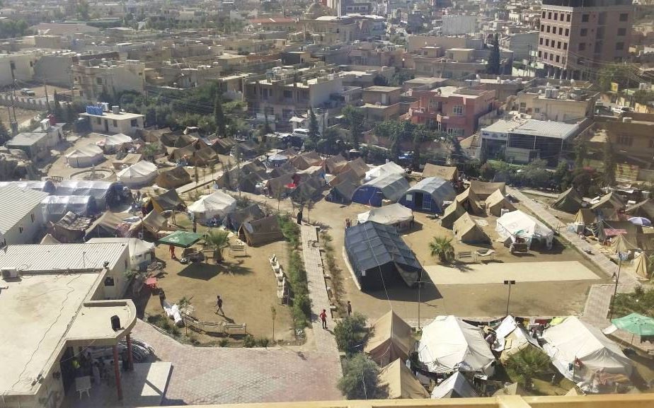 ERBIL. Egyptische kerken steunen gevluchte christenen in een vluchtelingenkamp in Noord-Irak. Op de voorgrond de zwarte tent met kruis waarin diensten worden gehouden. beeld Peter Magdy