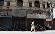 Een verlaten markt in Pakistan donderdag. Allerlei openbare activiteiten in het land zijn donderdag stilgelegd na de vrijspraak van Asia Bibi. beeld EPA, Rehan Khan