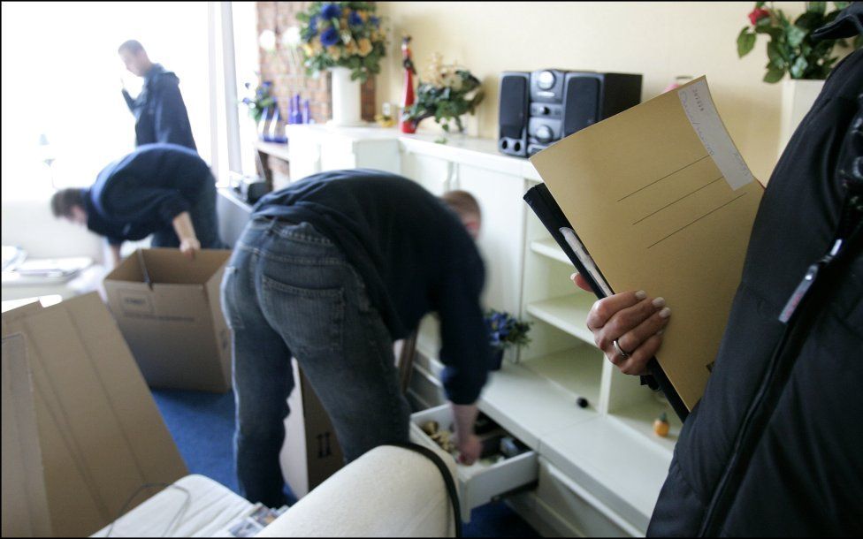 Deurwaarders ruimen een huis leeg. Foto ANP