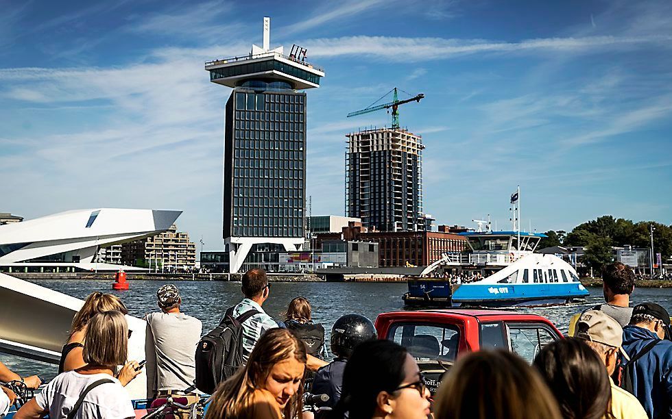 De woontoren B'mine achter de A'DAM toren op de noordelijke IJ-oever in Amsterdam. De bevolking van de hoofdstad blijft de komende jaren groeien blijkt volgens een gezamenlijk rapport van het CBS en Planbureau voor de Leefomgeving en het Centraal Bureau v